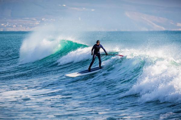 a man is riding a wave on a surfboard in the ocean .