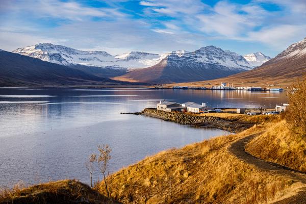 a lake with mountains in the background and a path leading to it .