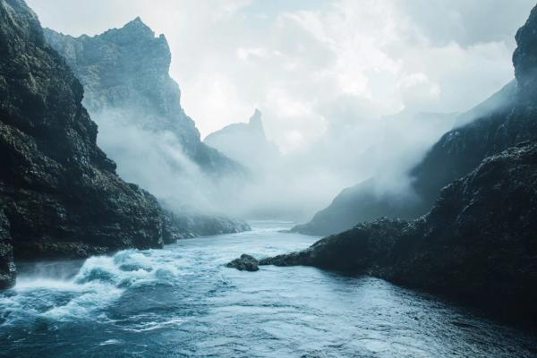 Fog between coastal rocks and sea