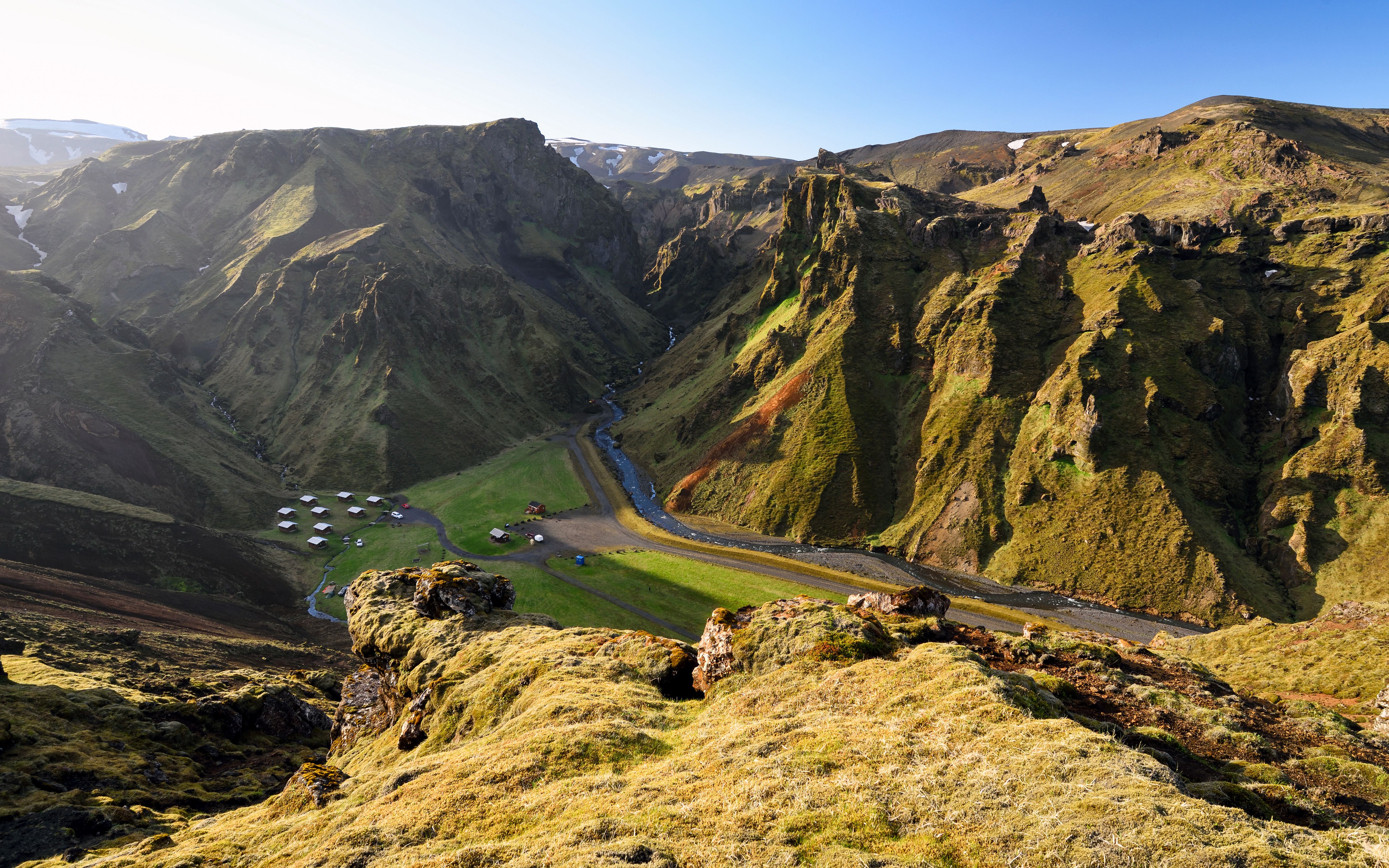 a view of a valley from the top of a mountain .