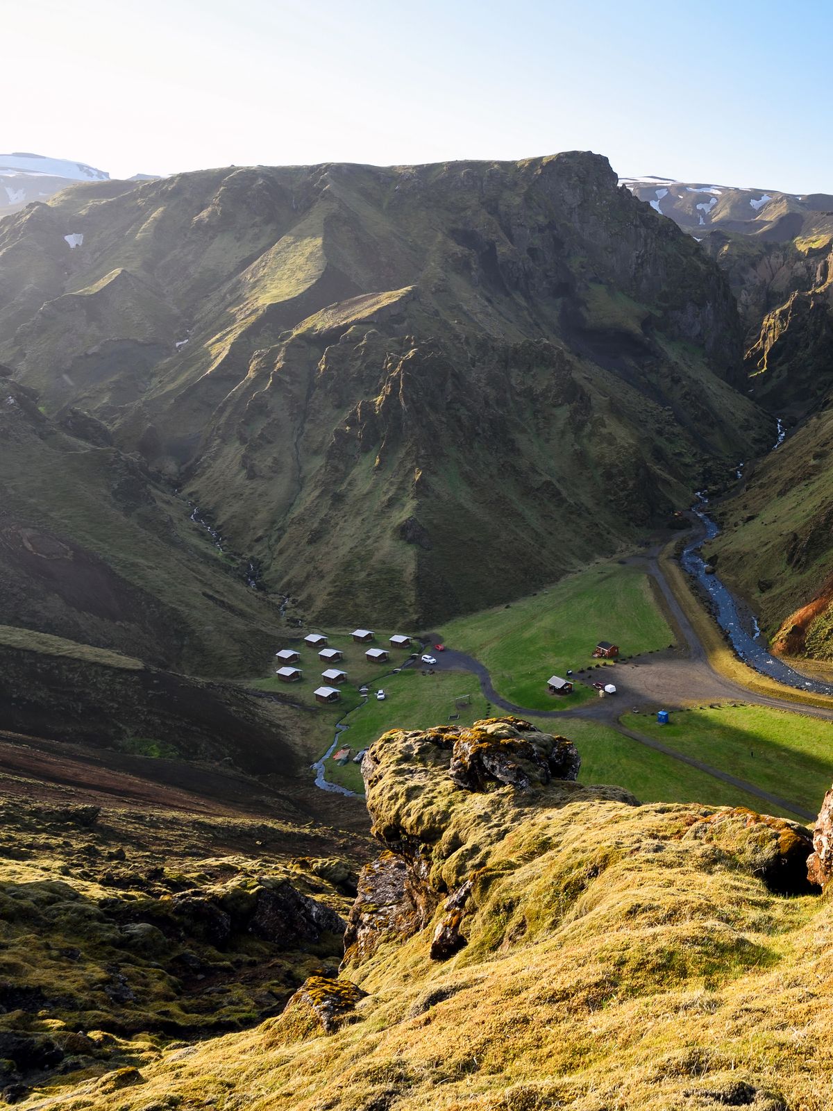 a view of a valley from the top of a mountain .