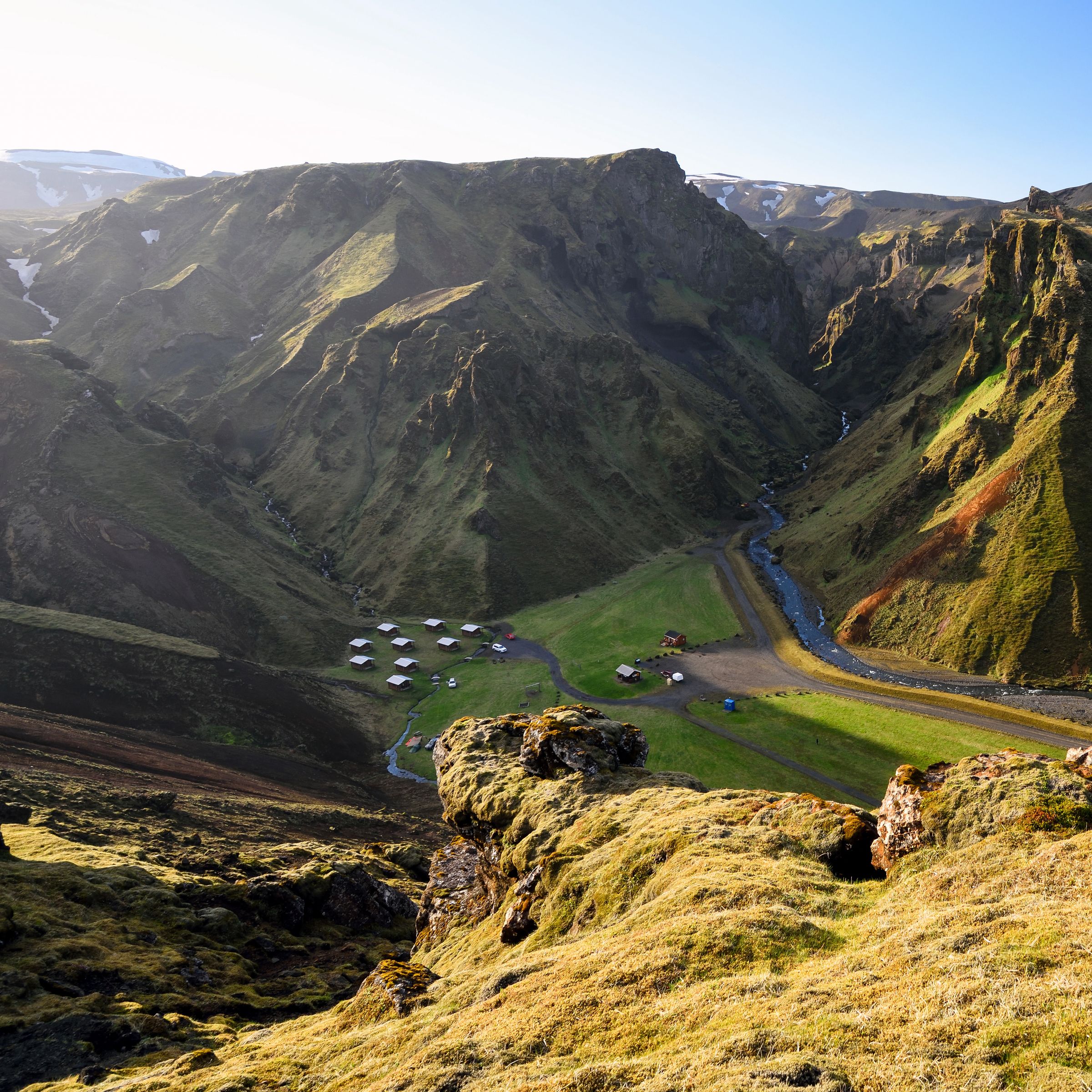 a view of a valley from the top of a mountain .