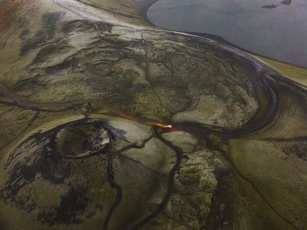 an aerial view of a volcano with a river running through it .