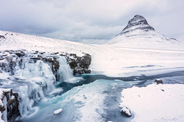 Kirkjufell and Kirkjufellsfoss completelt covered in snow in winter