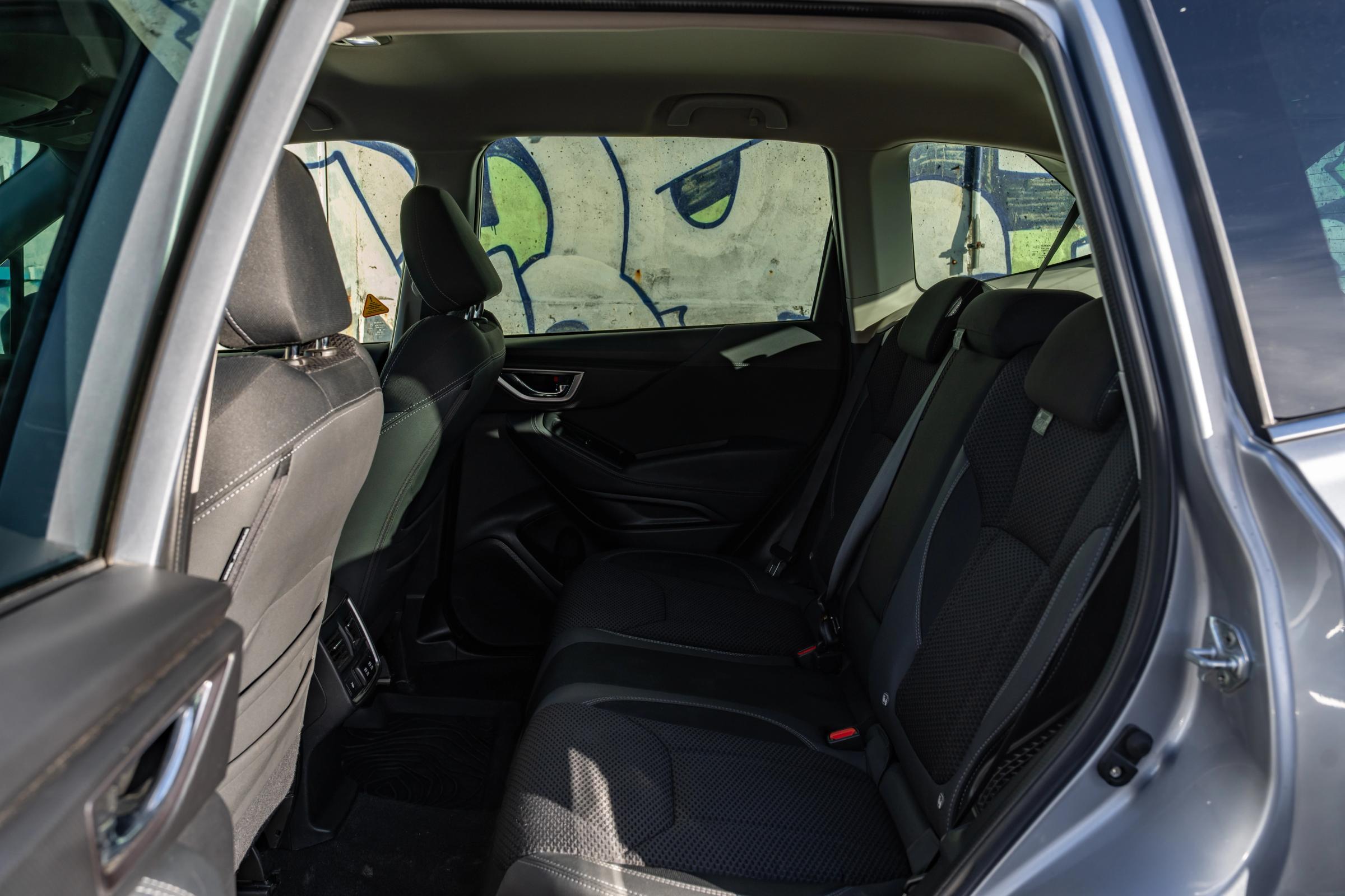 Subaru Forester rear bench seat and legroom through the open door, with rear air vents