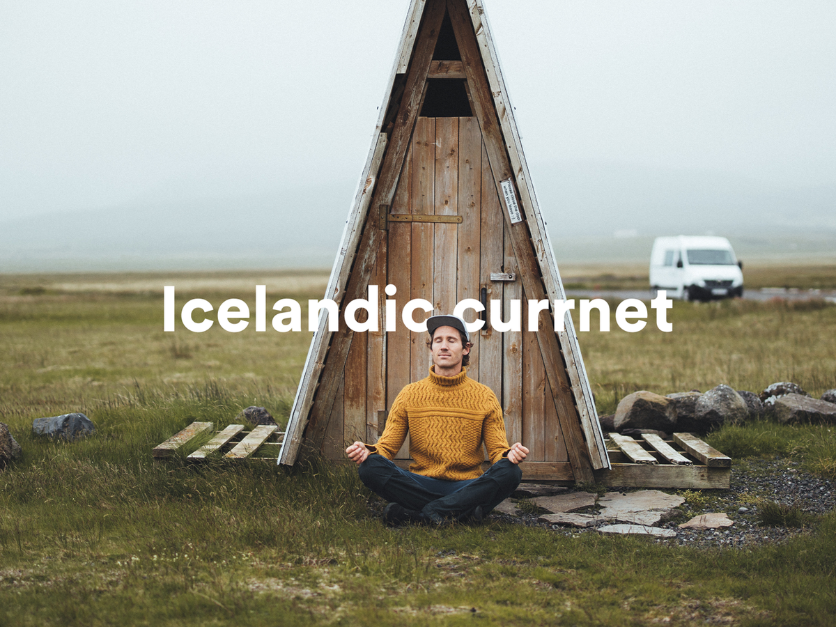 a man sits in a lotus position in front of an icelandic curmnet