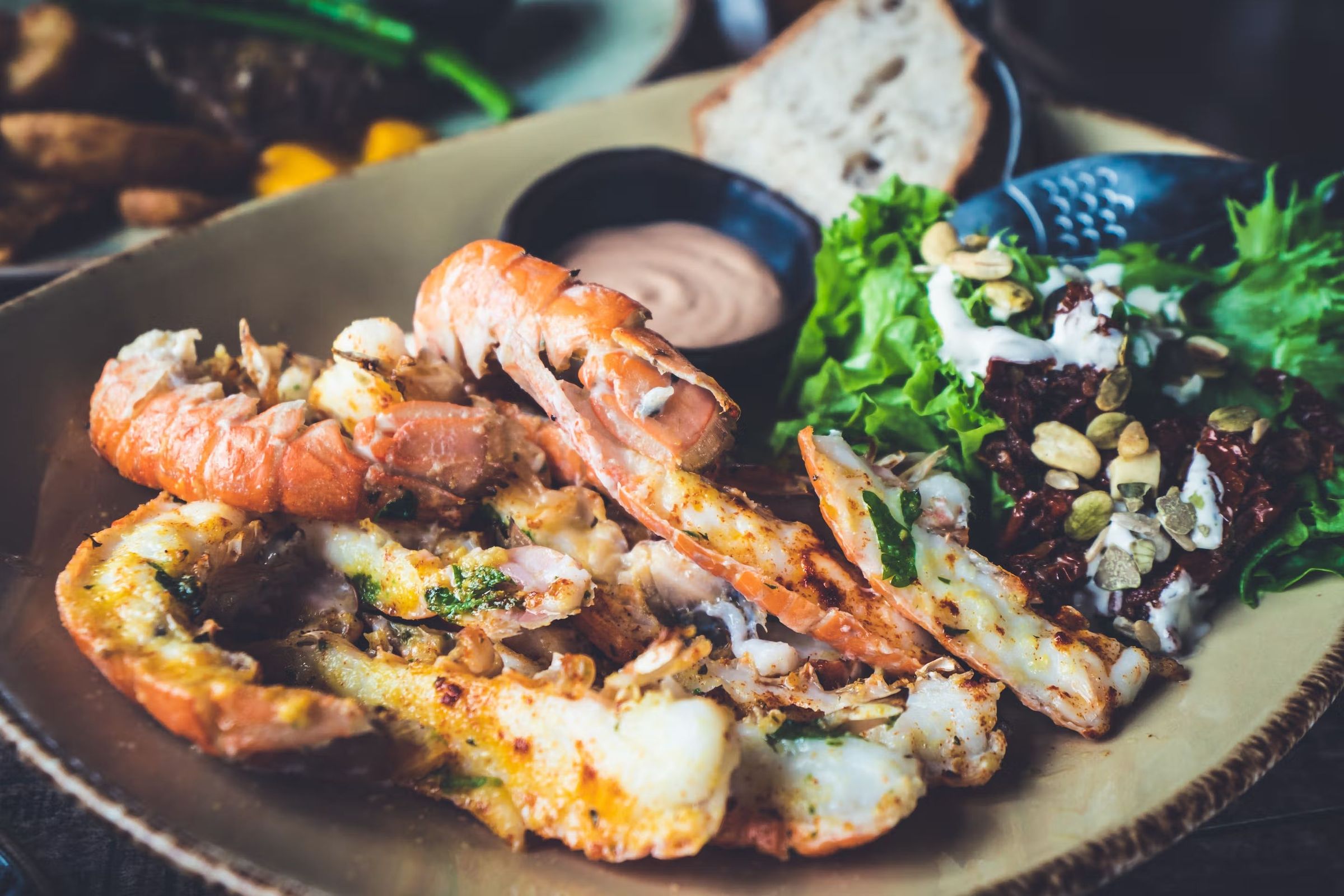 a close up of a plate of shrimp and salad on a table .