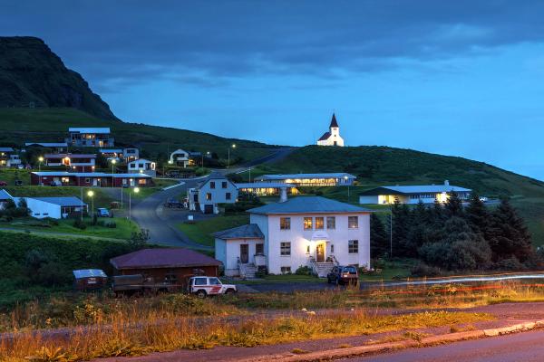 Village with white houses and a church on the hill