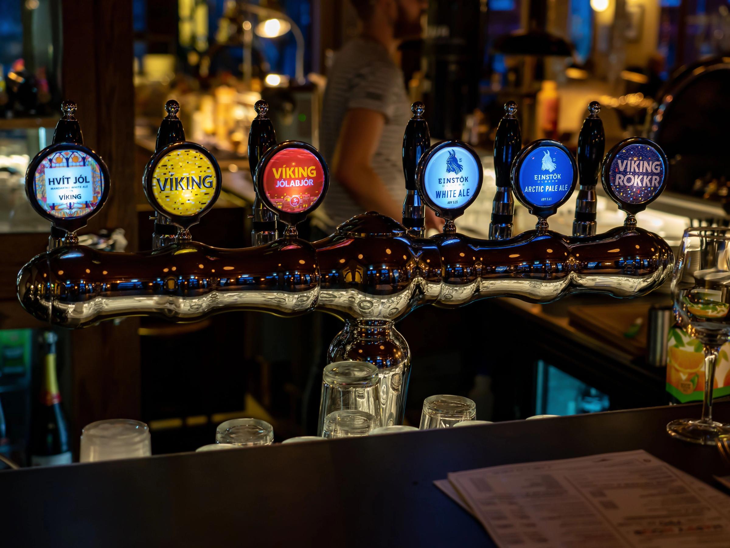 a bar with a lot of beer taps on it .