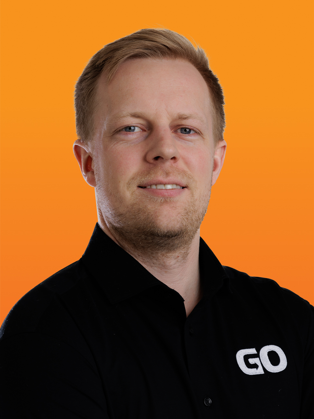 a man wearing a black shirt with the word go on it