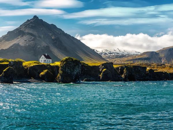 White house by a cliff in Arnarstapi