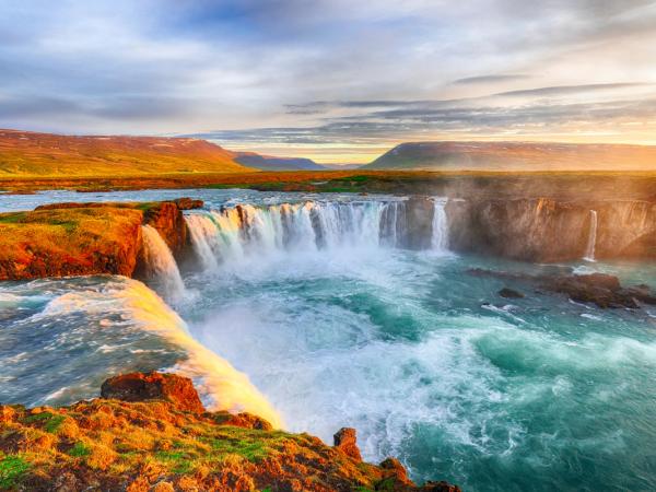 a powerful waterfall with autumn colors