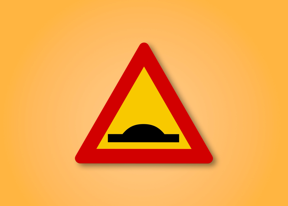 a yellow and red triangle with a black bump in the middle