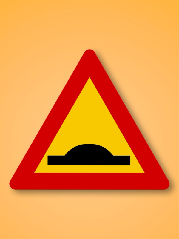 a yellow and red triangle with a black bump in the middle