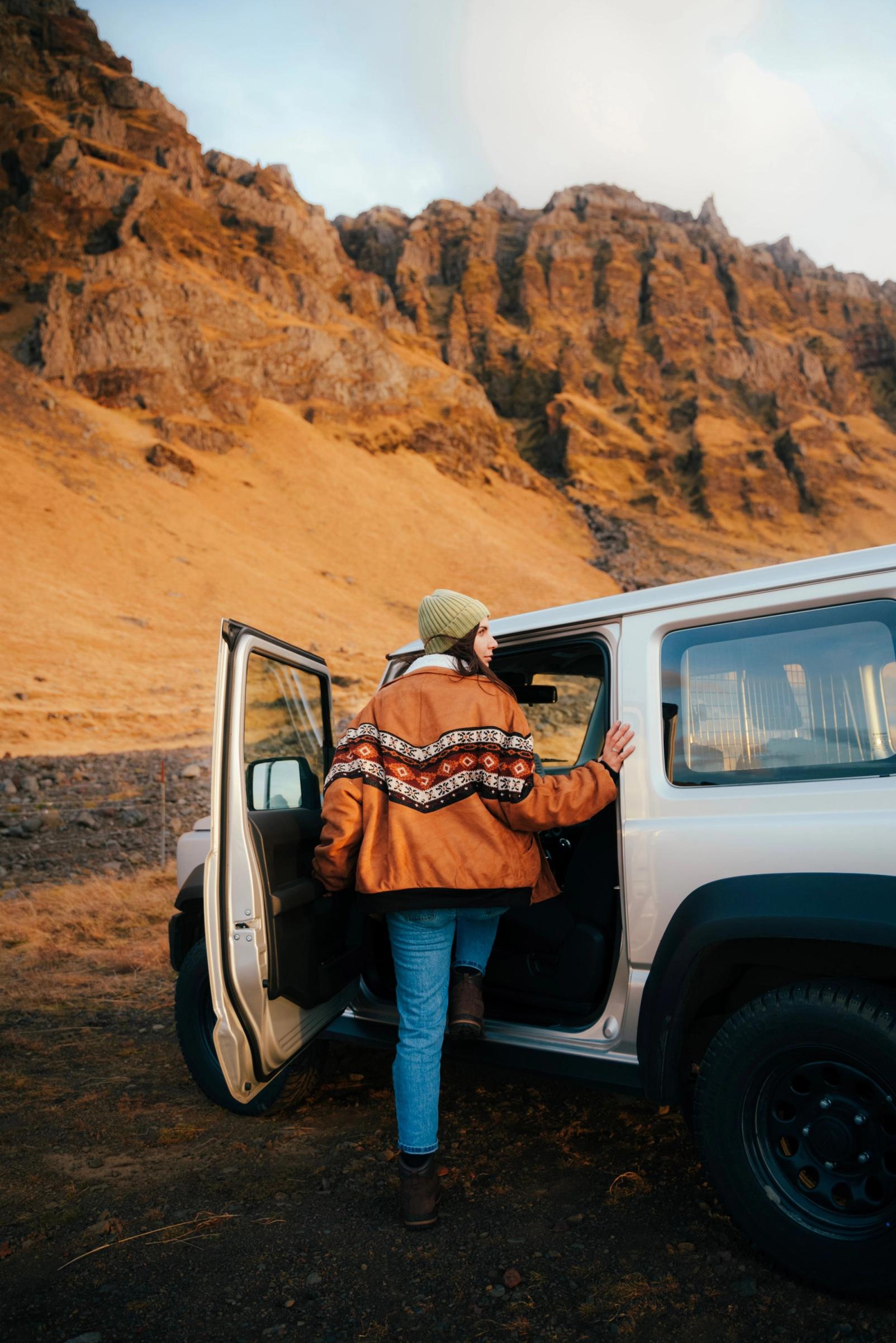 Girl getting into her rental car in Iceland