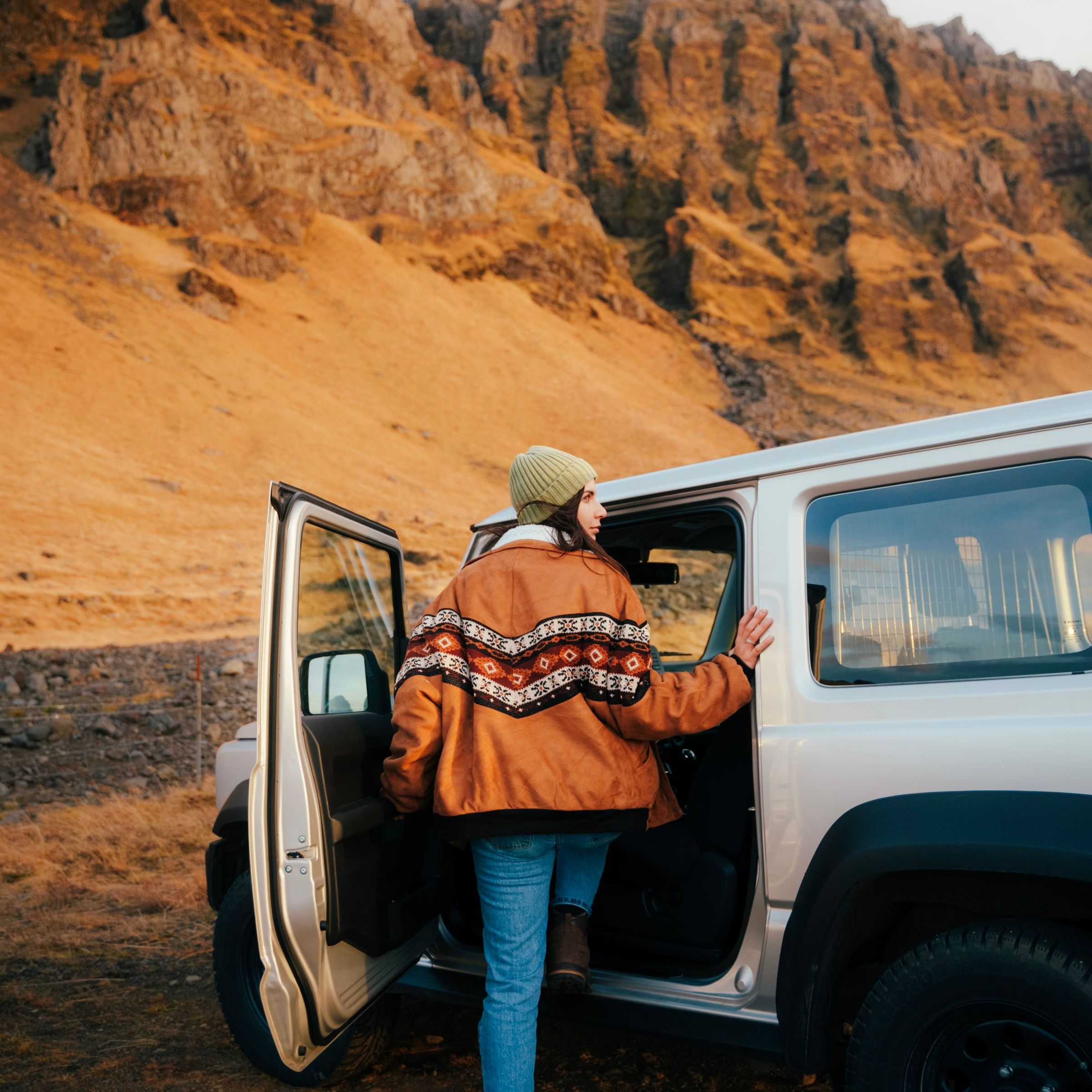 Girl getting into her rental car in Iceland