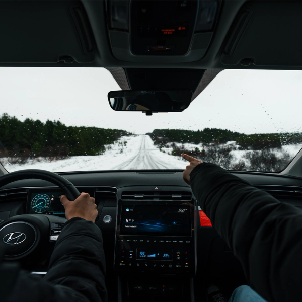 People inside a car in an snowy road in Iceland