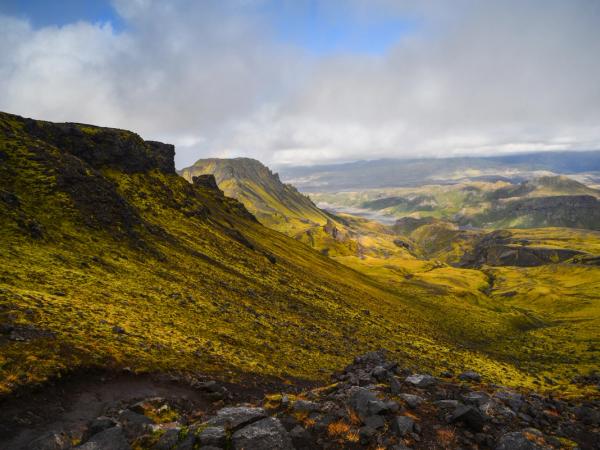 a view of a mountain valley from the top of a hill on a cloudy day, Fimmvörðuháls Hike