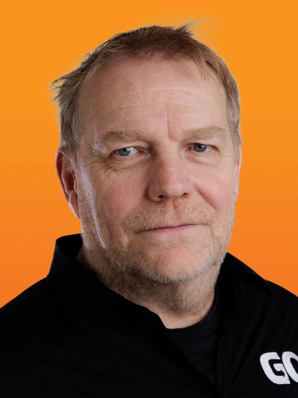 a man with a beard is wearing a black shirt with the word go on it .