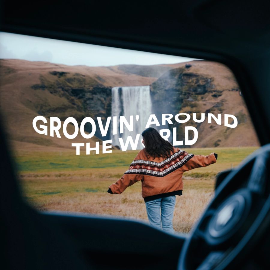 a woman is standing in front of a waterfall with the words groovin around the world above her