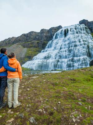 Iceland in September A couple watching a waterfall in iceland in September