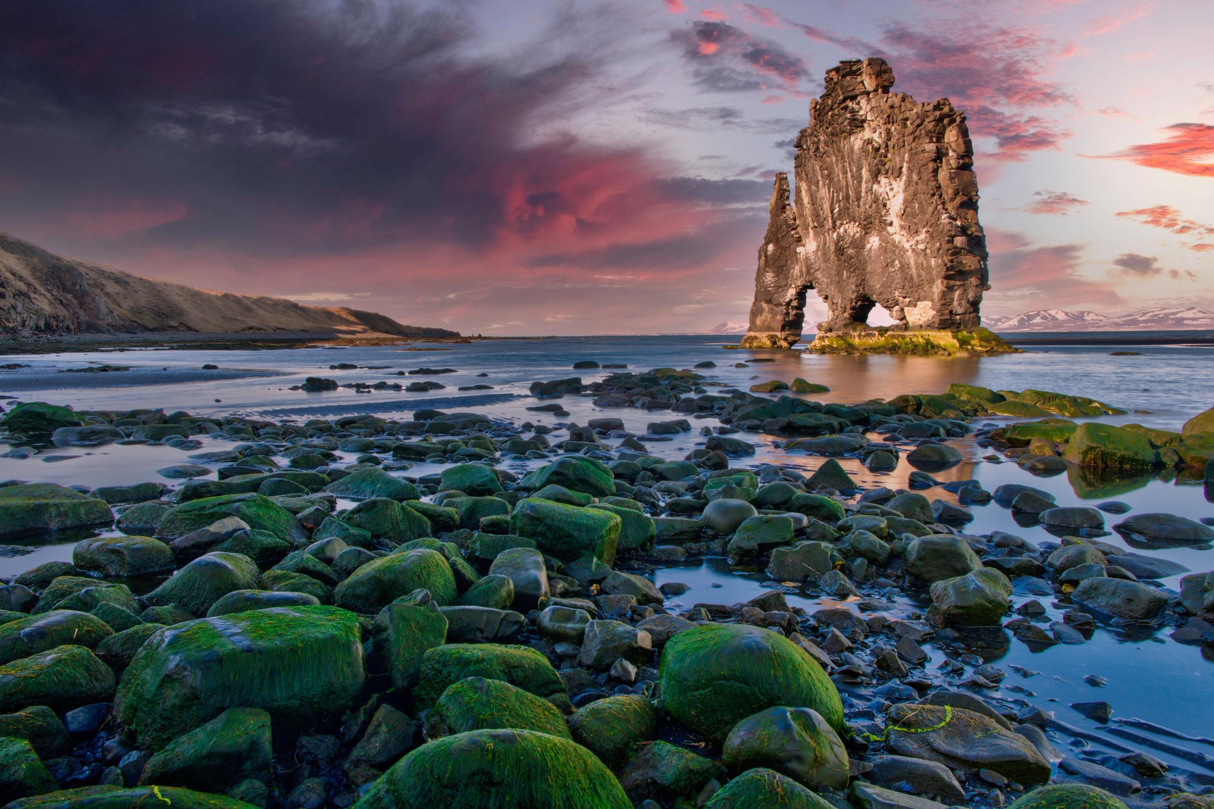 there is a large rock in the middle of the ocean .
