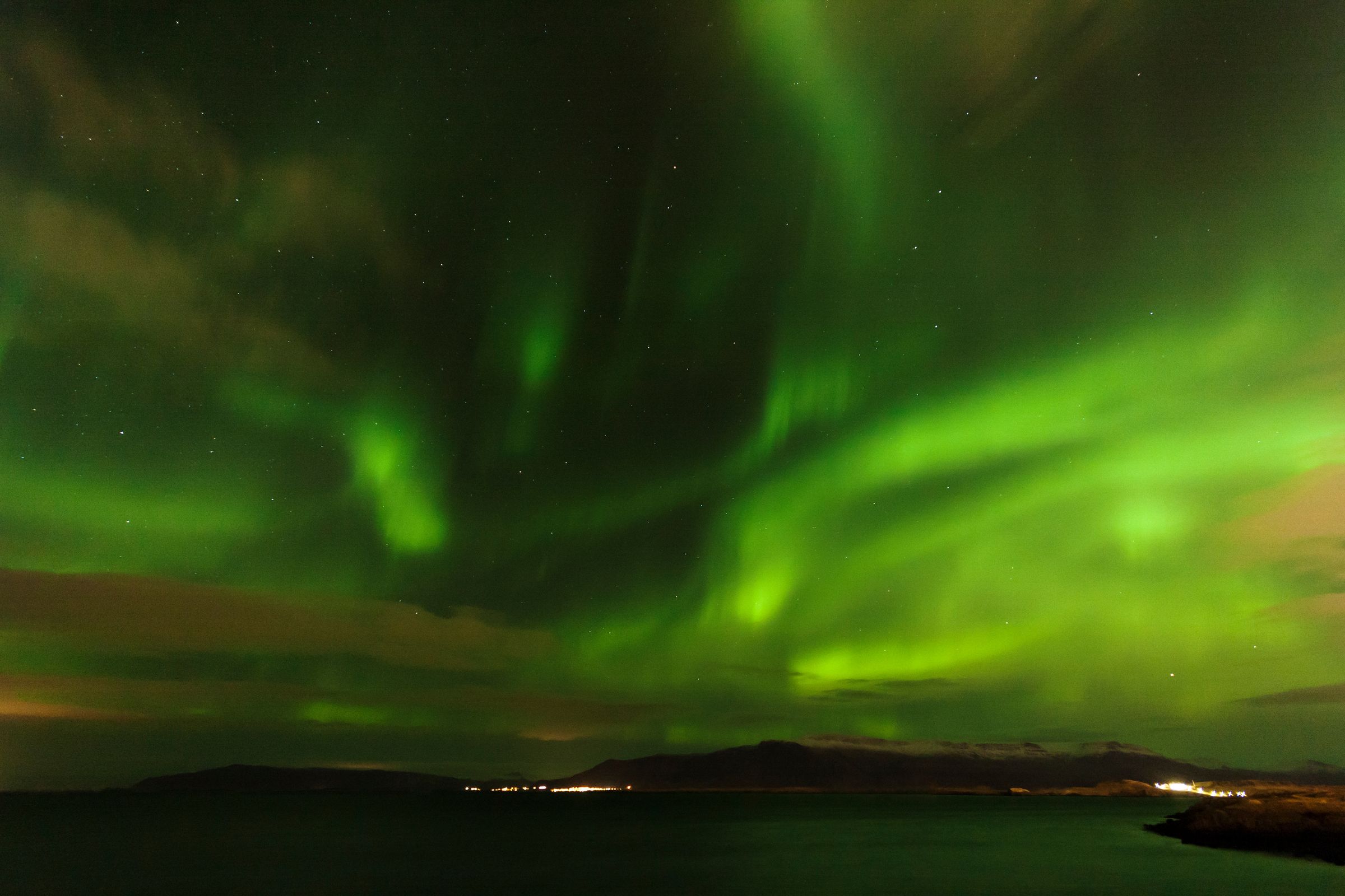 The Northern Lights dancing above a fiord