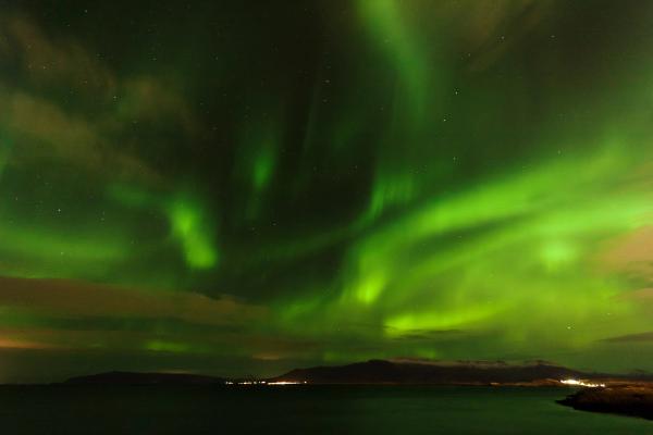 The Northern Lights dancing above a fiord