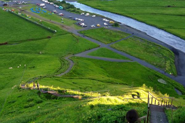 aerial view of skogar campsite with stairs that decent from the Skogafoss waterfall