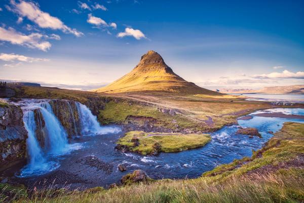 a waterfall and a mountain in a clear day