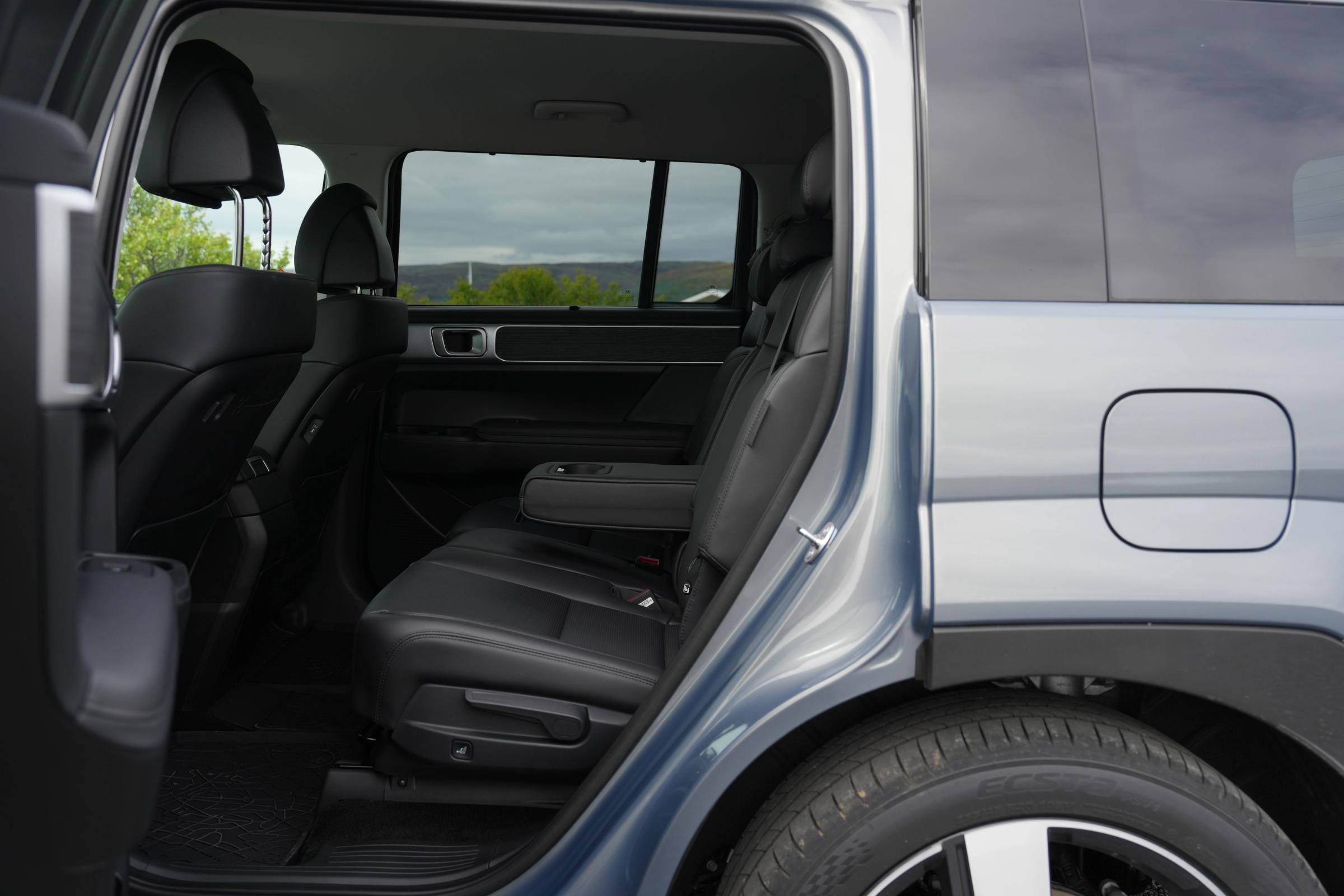 Hyundai Santa Fe second row seating in black leather seen through the open rear door