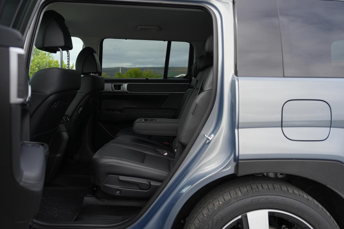 Hyundai Santa Fe second row seating in black leather seen through the open rear door