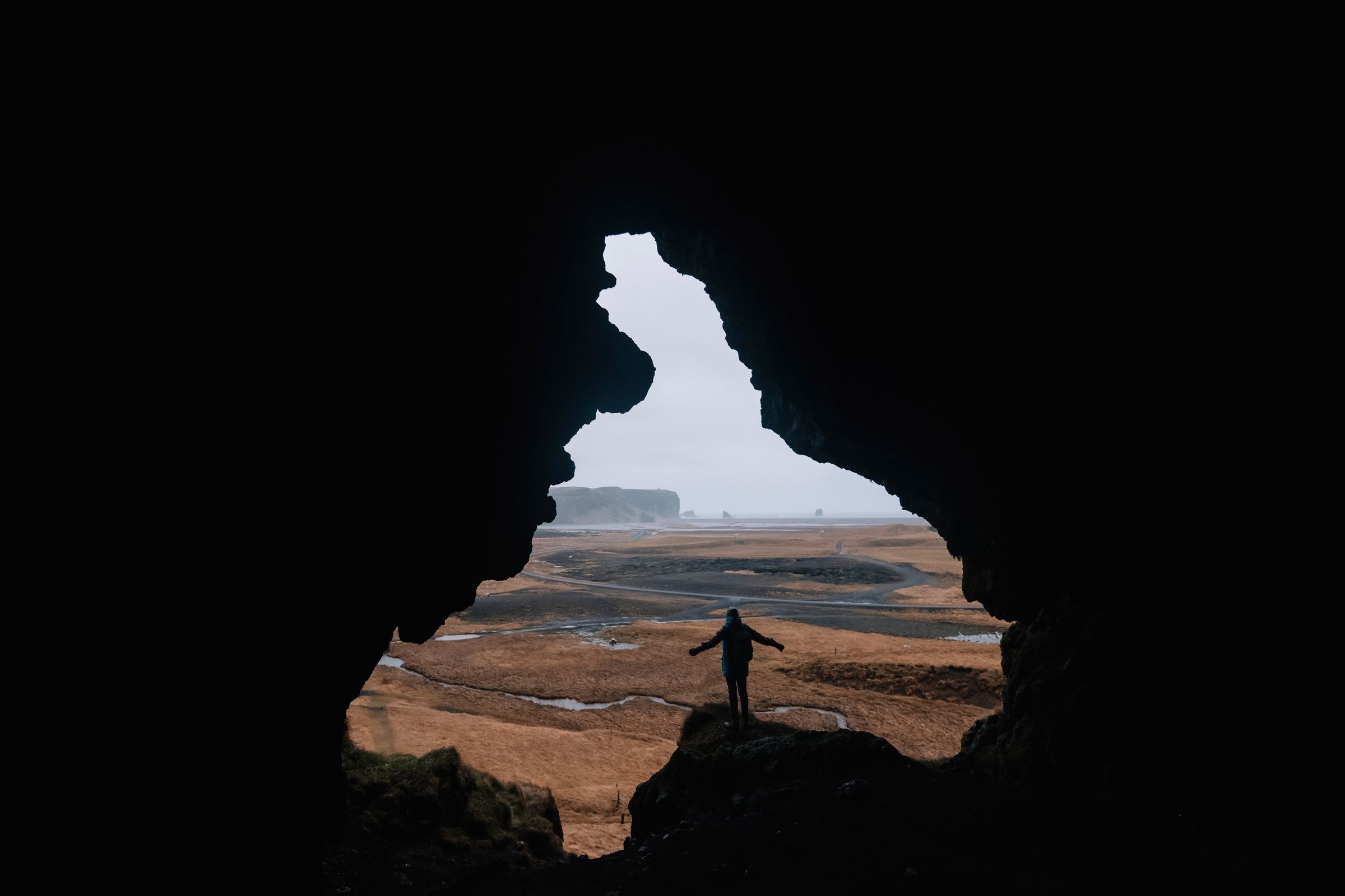 a person is standing in a cave with their arms outstretched at loftsalahellir in iceland.