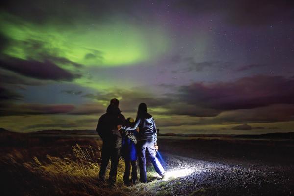 Family admiring the Northern Lights in Iceland