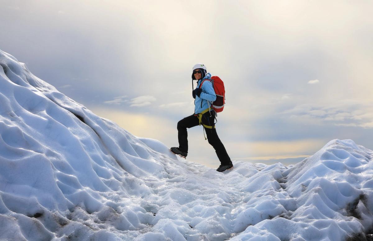 iceland weather january: The girl climbing the glacier in Iceland
