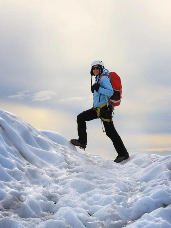 iceland weather january: The girl climbing the glacier in Iceland