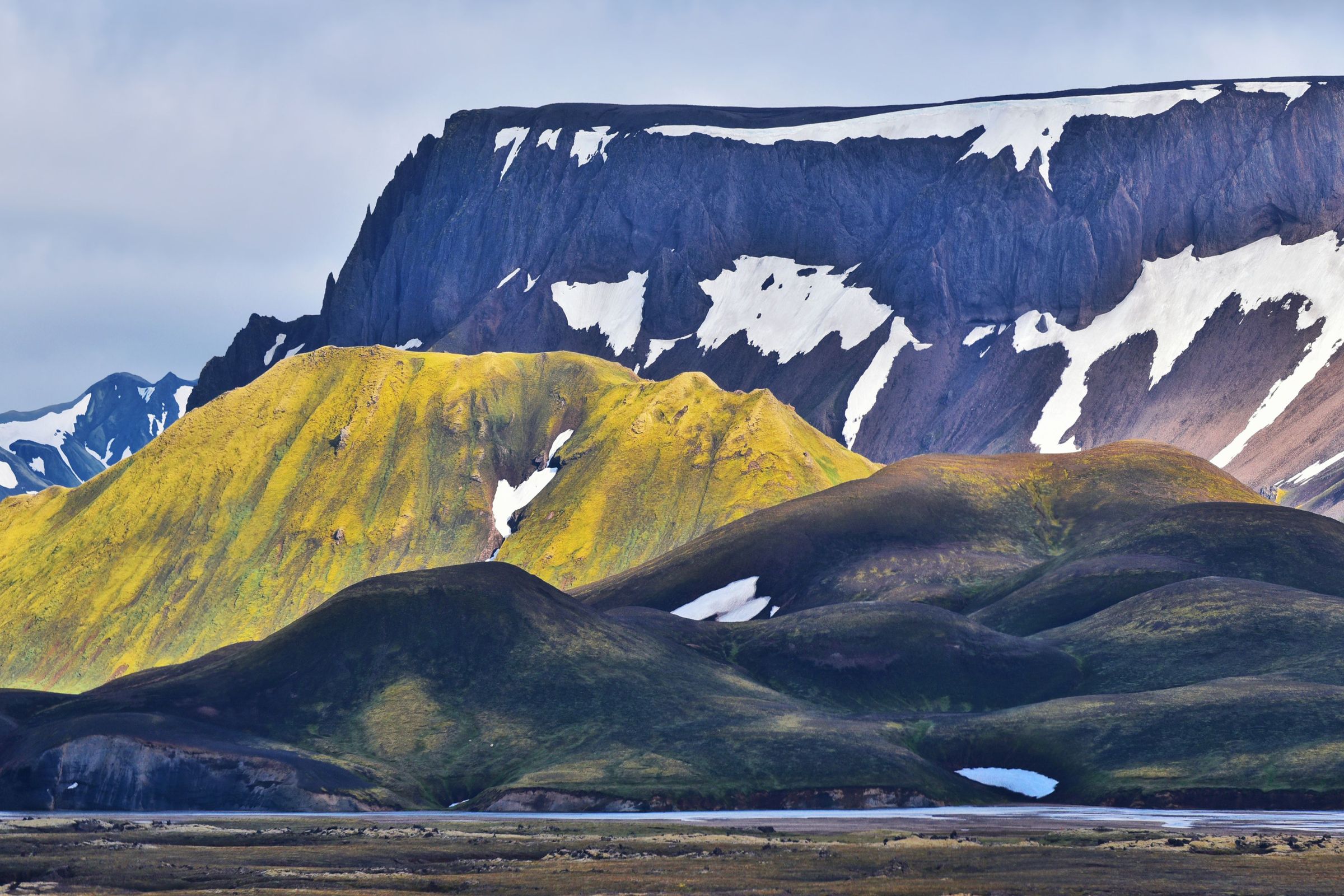mountains with different sizes partially covered by snow
