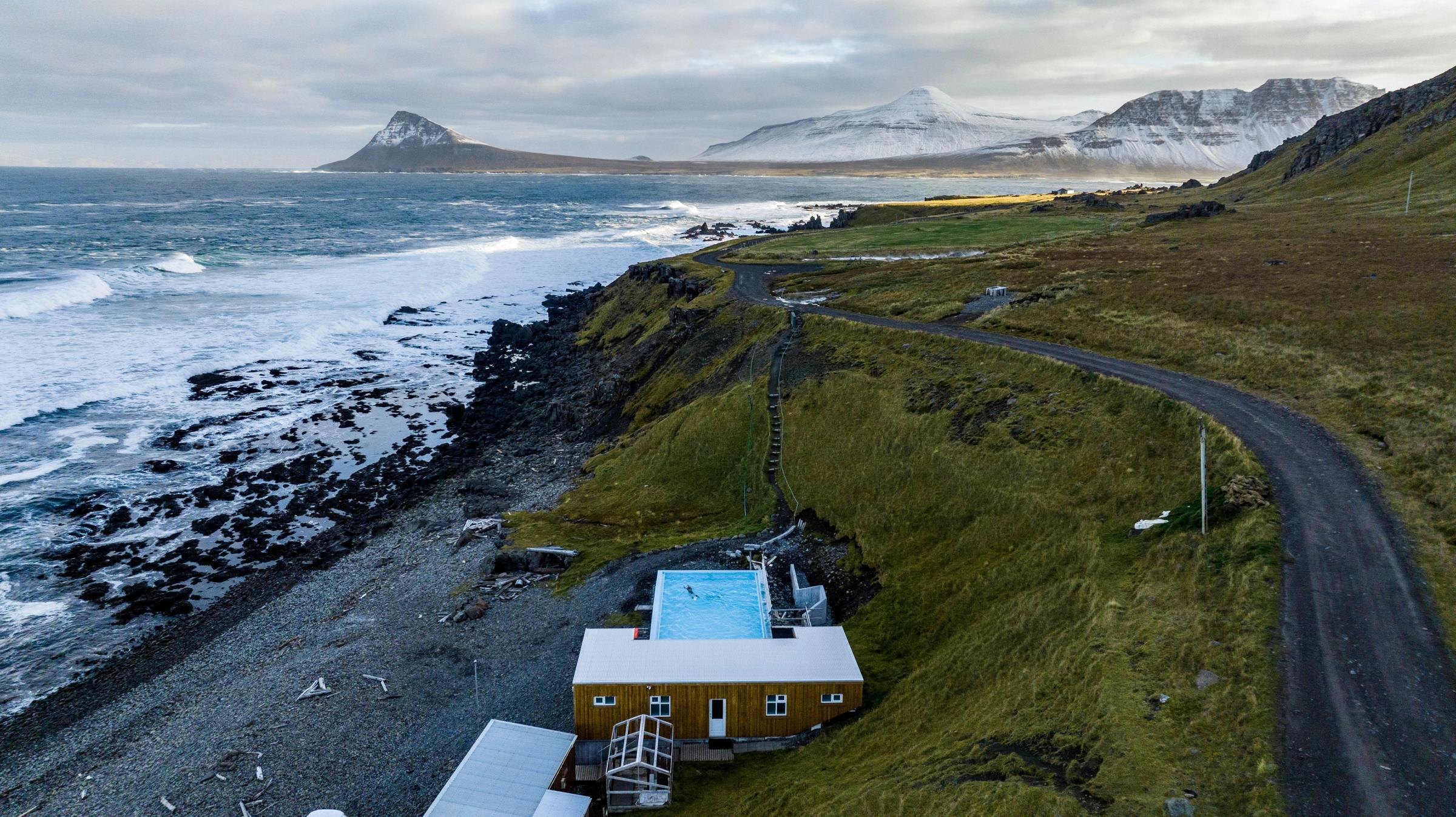 an aerial view of a house on a cliff overlooking the ocean .
