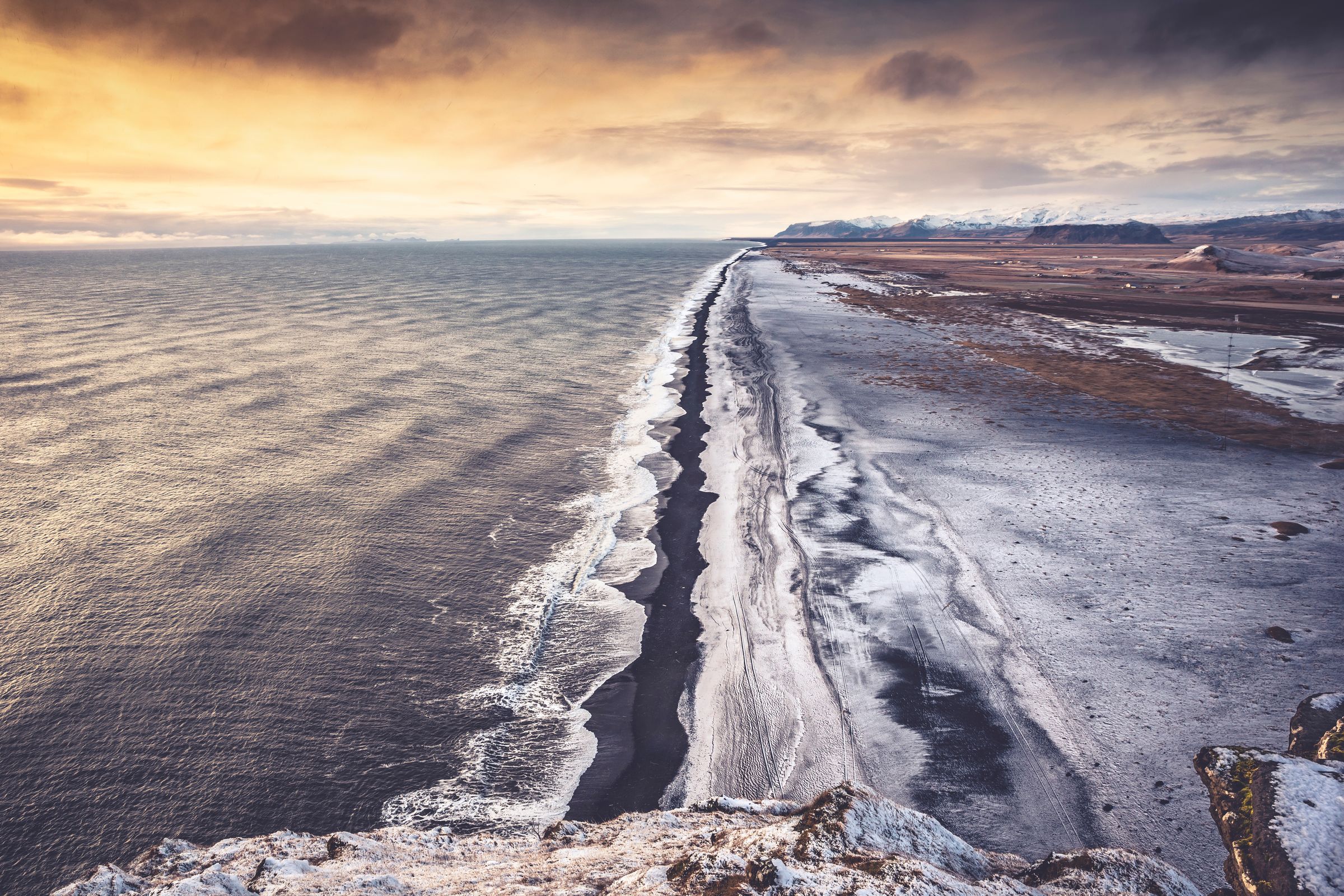 Black sand beach seen from a cliff