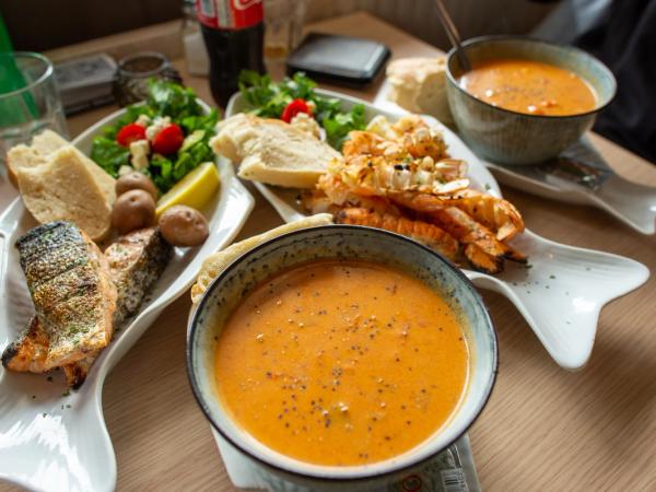 a restaurant table with different fish dishes