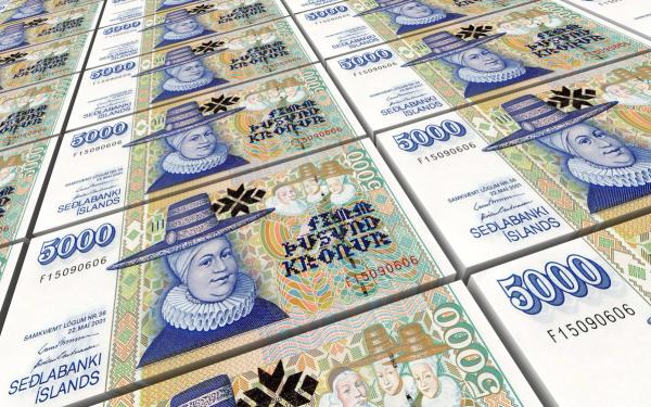 a bunch of stacks of icelandic banknotes stacked on top of each other .