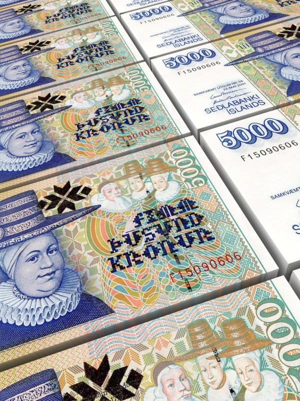 a bunch of stacks of icelandic banknotes stacked on top of each other .