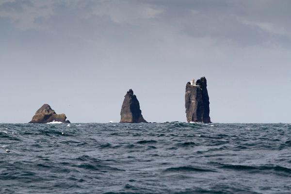 there are three rocks in the middle of the ocean .