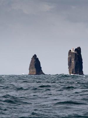 there are three rocks in the middle of the ocean .