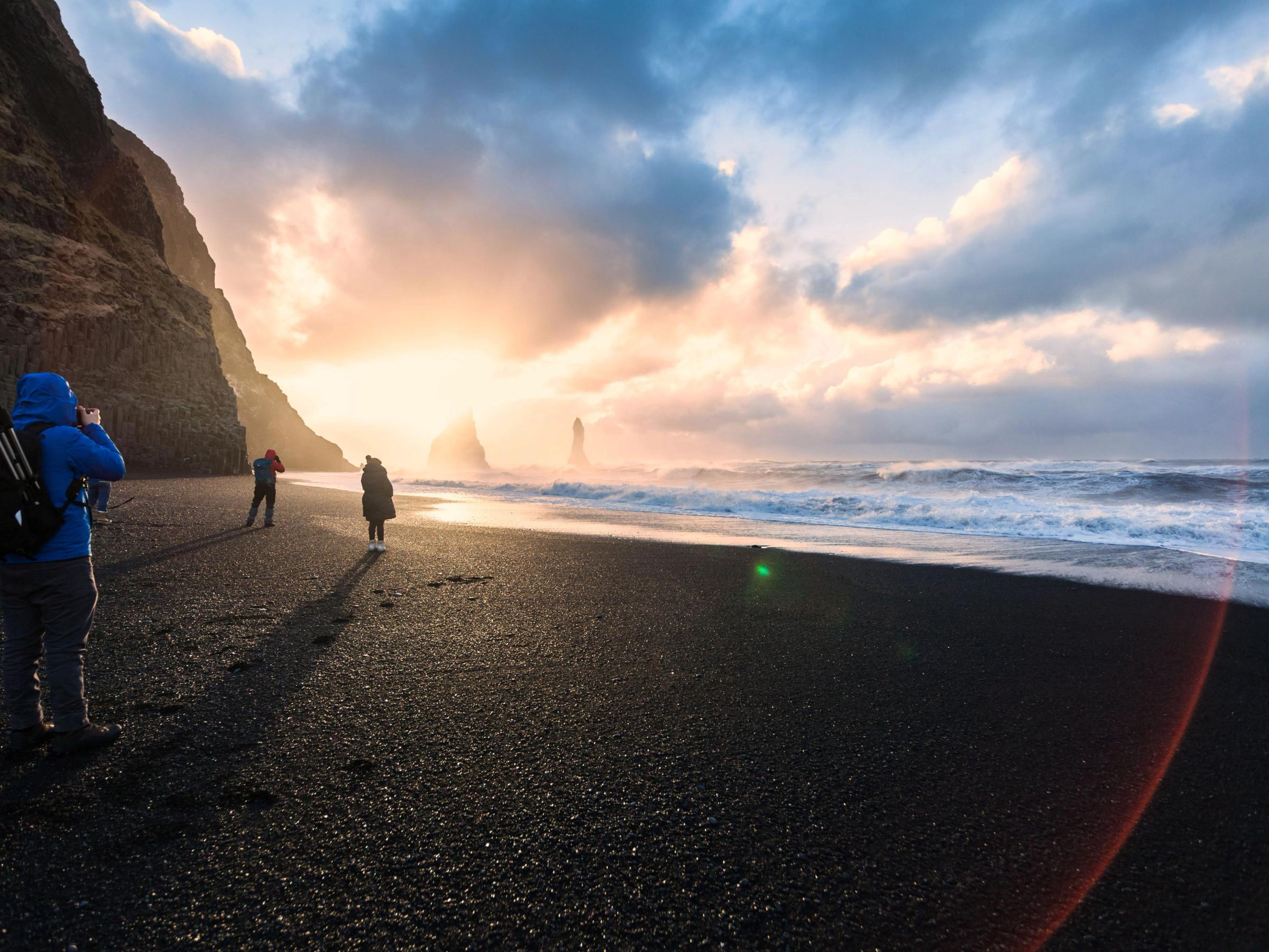 Man taking pictures in Reynisfjara Black Sand Beach
