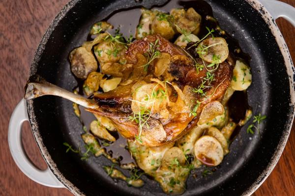 a close up of a pan filled with food on a wooden table .