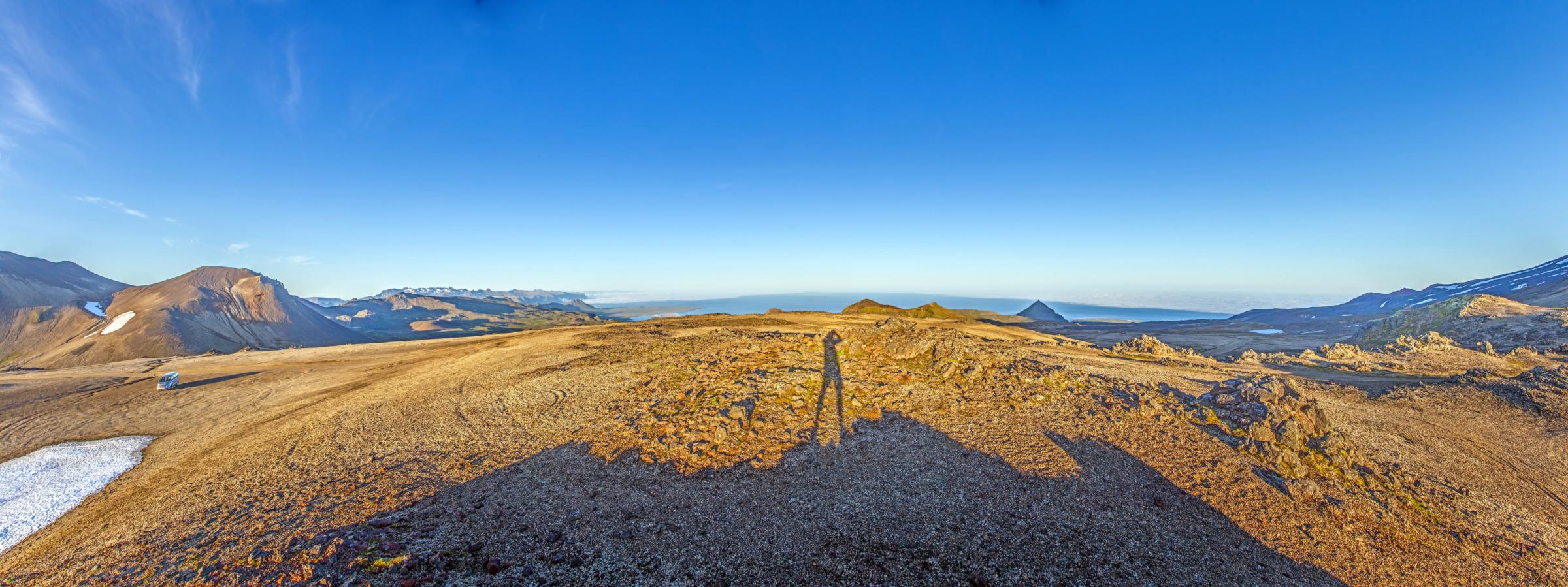 a person is standing on top of a mountain .