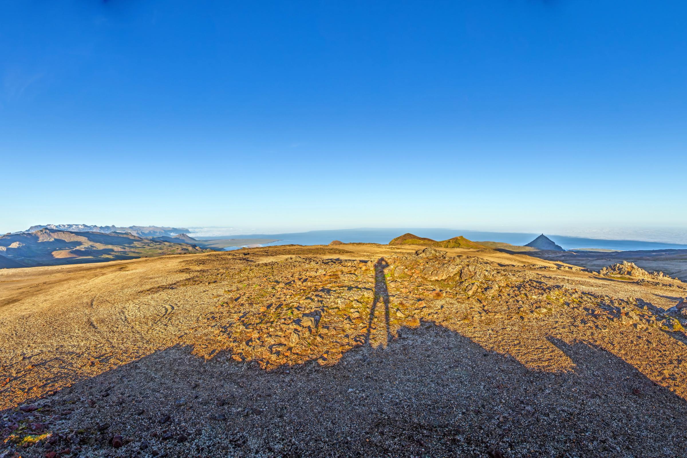 a person is standing on top of a mountain .