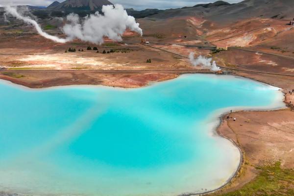 Geothermal activity next to a blue lake