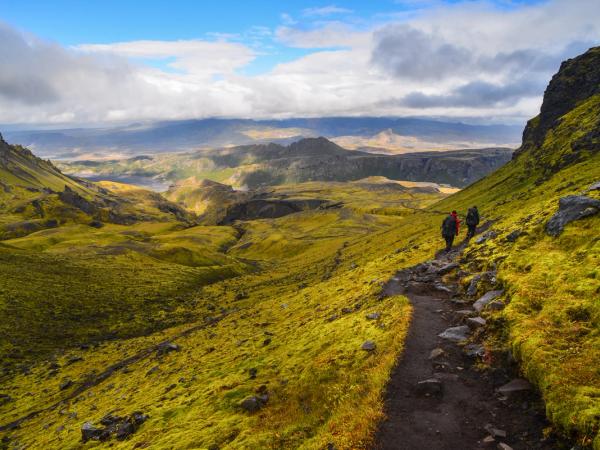 two people are hiking down a path in the mountains, Fimmvörðuháls Hike
